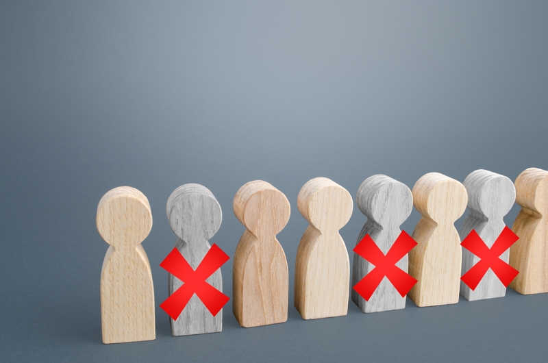 Eight wooden figures representing people being laidoff.