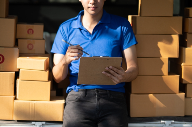 Professional delivery person checking delivery list.