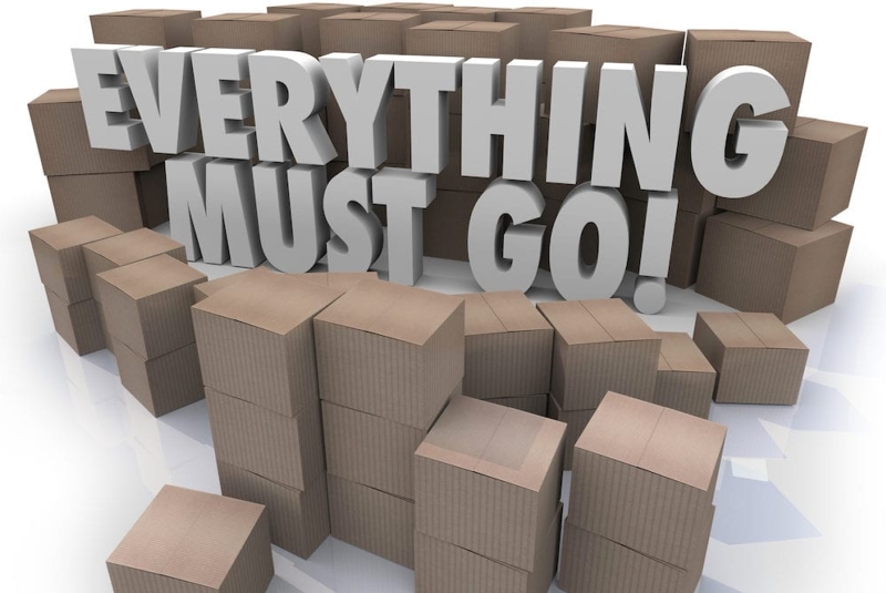 Everything must go sign surrounded by brown boxes.