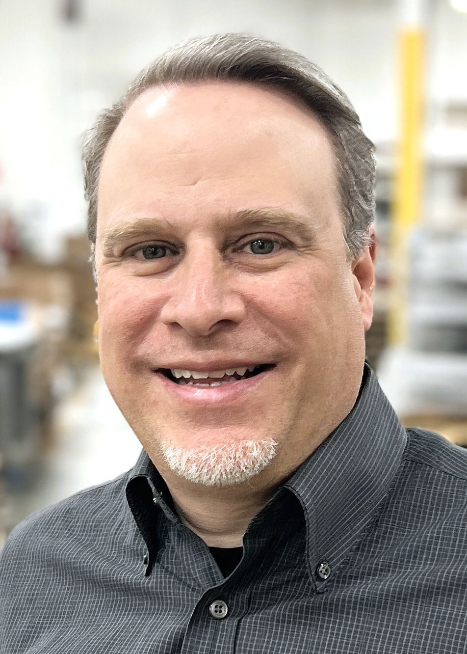 image of man with light brown hair wearing a dark gray collared shirt